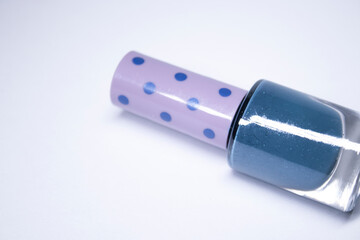 A bottle with blue nail polish on white background. nail lacquer. Nail manicure concept. Isolated, copy space. 
