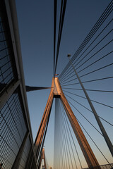 Obraz premium View of a pylon with attached cables holding up a cable suspended bridge.