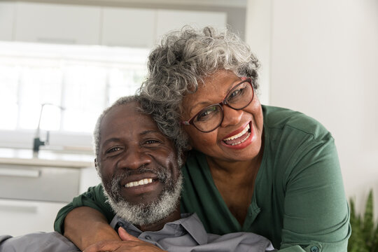 A senior African American couple smiling at the camera