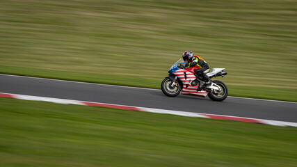 Fototapeta premium A panning shot of a racing bike cornering on a track