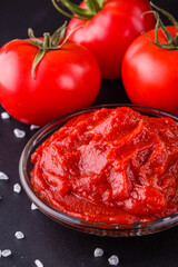 fresh natural tomato paste on black background