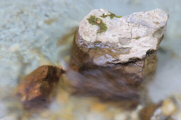 Stream, rocks and water in autumn forest.