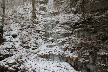 Fototapeta na wymiar Frozen water, waterfall in the nature. Cold winter day.