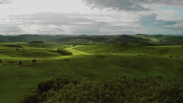 Flying over the amazing rolling hills of Tuscany Italy at sunset