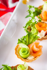 delicious snack tartlets on rustic wooden background