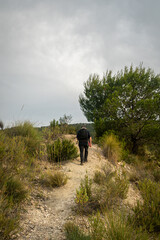 Man walking through the Embalse del Mayes in Murcia. Spain.