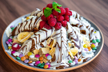Sweet Waffles with milk chocolate, white chocolate, vanilla cream, strawberries, banana, vanilla ice cream sweet popcorn
