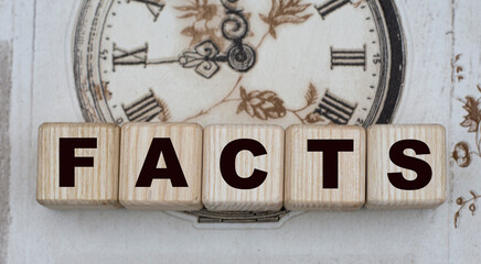 FACTS word on cubes on a background of drawn vintage watches