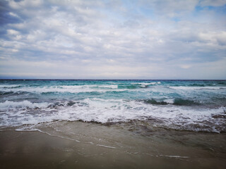 Fototapeta na wymiar Scenic landscape with sea waves on cloudy sky background