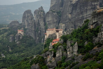 Fototapeta na wymiar Tele view of orthodox monasteries of Meteora (Greece) nestled in a stunning mountain landscape 