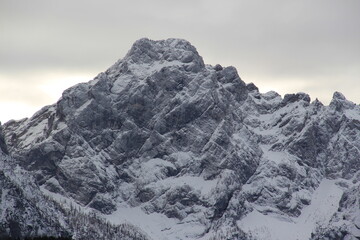 Fototapeta na wymiar Dangerous misty, snowy mountains at winter.
