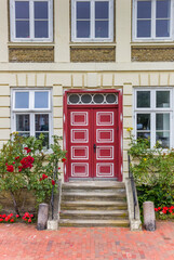 Fototapeta na wymiar Red door at a historic house in Gluckstadt