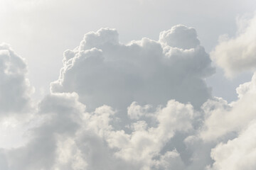 White big fluffy clouds. Natural scenic abstract background. Weather changes backdrop. Sky filled with voluminous clouds.