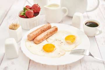 Healthly food. Continental breakfast in hotel room or bed. Fried eggs with sausages. Cup of coffee....