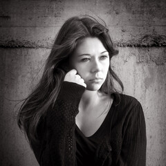 Teenage girl looking thoughtful about troubles, black and white photo