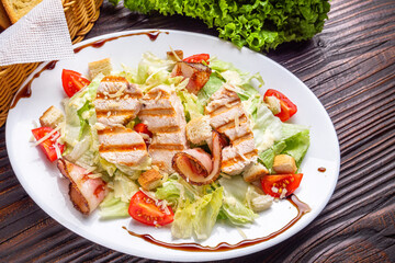 Caesar salad on dark wooden rustic background