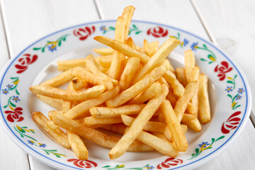 golden french fries on the wooden background
