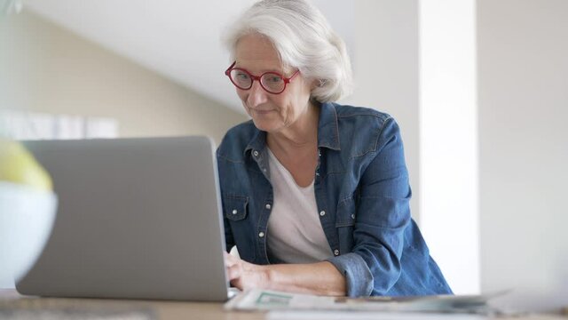 Senior woman using laptop computer at home