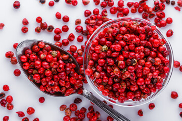 fragrant pink peppercorns on white acrylic background