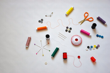 Top view of the sewing tools and accesories on the white background