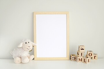 Wooden frame mock up for photo, print art, text or lettering, with nursery  toys. Blank frame on white table.