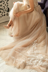 Fototapeta na wymiar Bride in luxury wedding dress and shoes on high heels