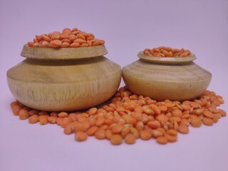Traditional wooden pots containing pulses in white background.