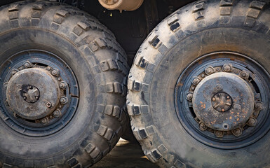 Huge old rubber tire of a large automotive vehicle. Selective focus.