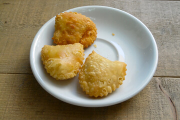 Pourekia or Bourekia - Traditional Cypriot pastry made with thin and flaky phyllo dough and filled with unsalted Αnari cheese on a wooden table