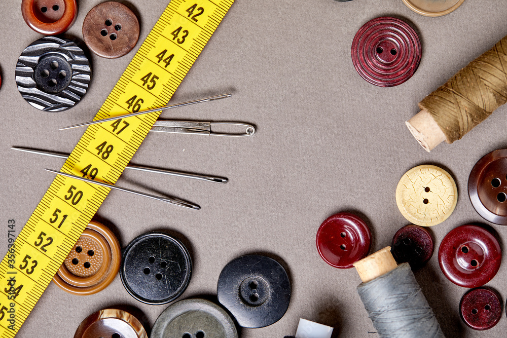 Aufkleber background and texture of multicolored antique buttons and sewing tools