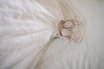 Wedding dress on the bed in the apartment