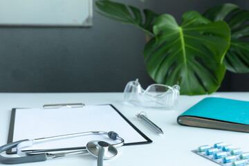 Doctor general practitioner desk. Healthcare insurance concept. Table top view essential doctor's equipment