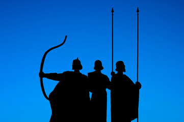 Heroes silhouettes on blue sky background