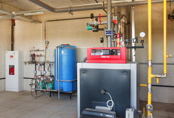 interior of a modern gas boiler room, with a water treatment system, many valves and sensors
