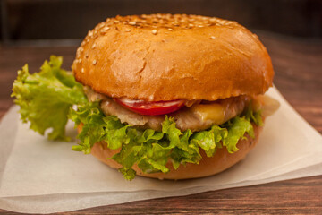 the Burger with the crispy bun, juicy Patty, tomato, cheese and salad