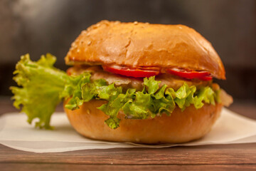 the Burger with the crispy bun, juicy Patty, tomato, cheese and salad