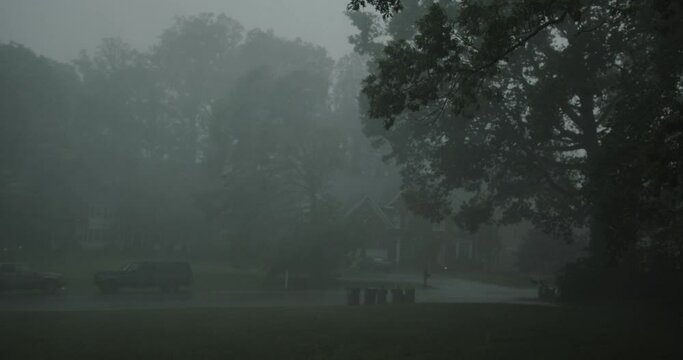 Torrential rain storm with lighting blows wildly through residential neighborhood - with audio