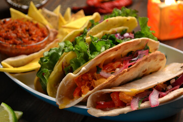 Mexican tacos with chicken, beef, paprika, lettuce, tomatoes and nachos, lime juice, tequila.