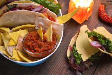 Mexican tacos with chicken, beef, paprika, lettuce, tomatoes and nachos, lime juice, tequila.