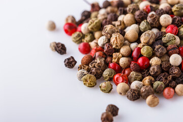 mix of peppercorns on white acrylic background