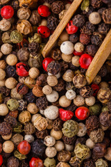 mix of peppercorns on white acrylic background
