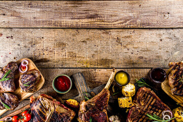 Set of various grilled meat, different beef steaks with sauces.Bbq beef steaks - chateau mignon, t-bone, tomahawk, striploin, tenderloin, new york steak. Wooden rustic background