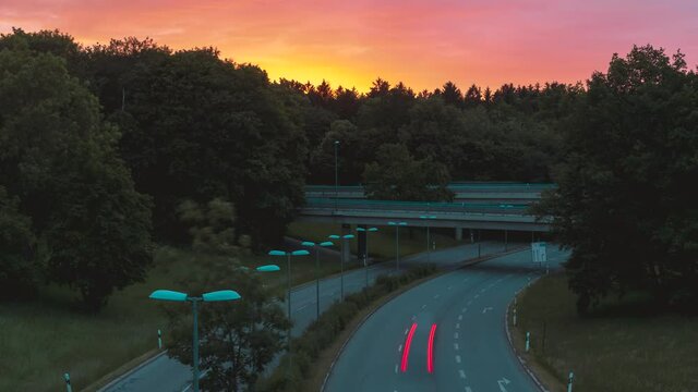 Time lapse of a street in a golden sunset. Hardly any traffic on the road due to the coronavirus. People stay at home in munich and do not use transportation.