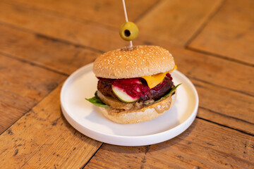 Tasty vegan burger on a wooden table.