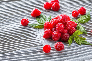 juicy fresh natural raspberries on a gray wooden rustic background