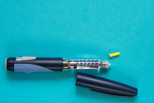 Diabetes. Ampoules with Insulin. Insulin syringe pen. Disposable needles. A healthy lifestyle diabetic. Macro photo. Blue free background. Shymkent, Kazakhstan May 25, 2020