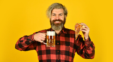 happy bearded man with beer and pizza. italian food. italy is here. guy in bar drinking beer and eating pizza. Cheers. glass of beer and pizza. watching football on TV. fast food