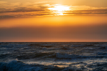 Stormy sea during sunset time