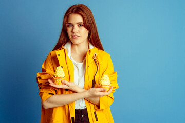 girl with yellow cupcake in yellow raincoat