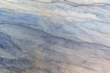 The texture of a multilayer stone is light blue. Background of a stone imitating waves.